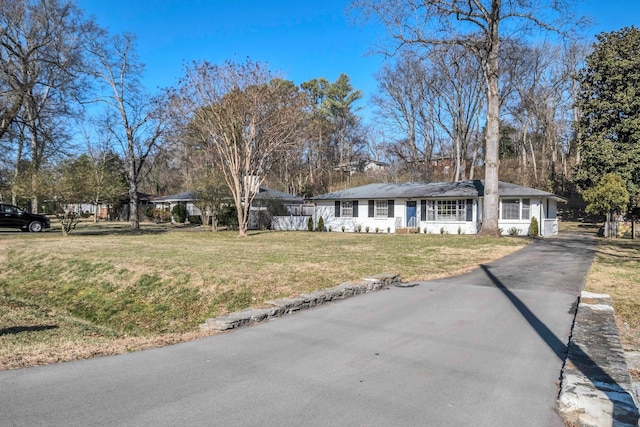 ranch-style home featuring a front yard