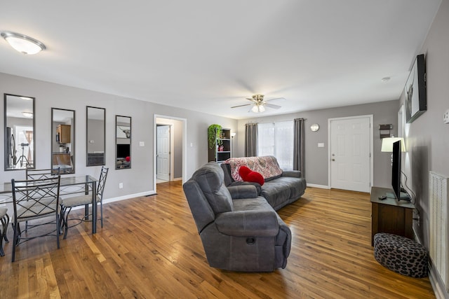 living room featuring hardwood / wood-style flooring and ceiling fan