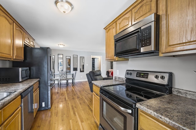 kitchen featuring stainless steel appliances and light hardwood / wood-style flooring