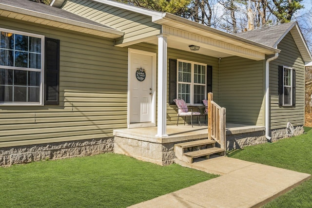 property entrance featuring a porch and a yard