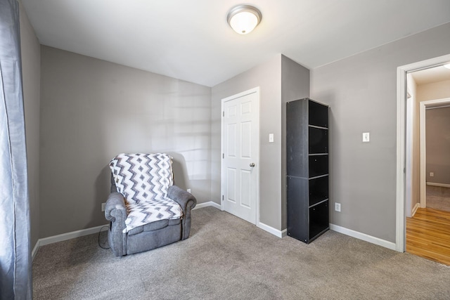 sitting room featuring light colored carpet