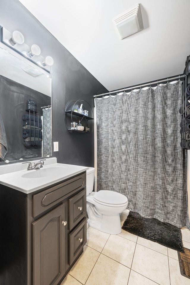 bathroom featuring vanity, walk in shower, tile patterned floors, and toilet