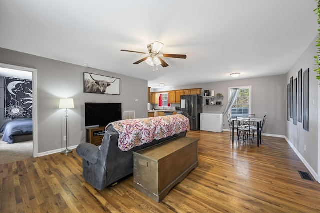 living room with dark hardwood / wood-style floors and ceiling fan