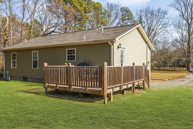 back of property with a yard and a deck