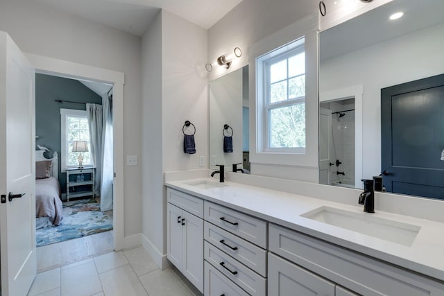 bathroom featuring vanity, a wealth of natural light, tile patterned floors, and shower / bathing tub combination