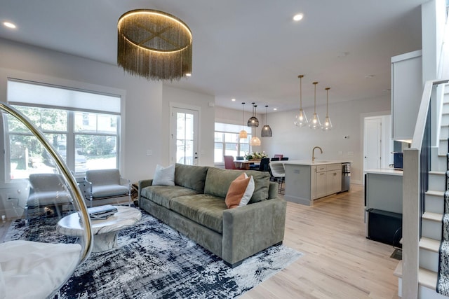 living room with sink and light hardwood / wood-style floors