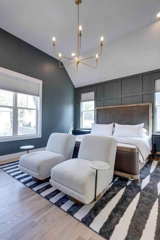 bedroom with lofted ceiling and hardwood / wood-style floors