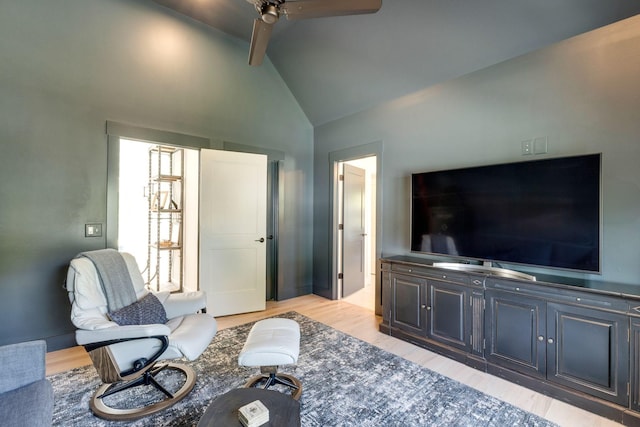 living room with high vaulted ceiling, ceiling fan, and light wood-type flooring