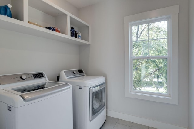 laundry area featuring separate washer and dryer and light tile patterned floors