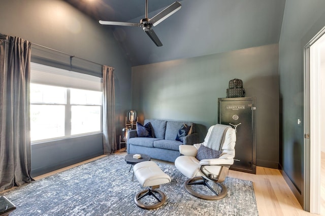 living room featuring ceiling fan, lofted ceiling, and light hardwood / wood-style floors