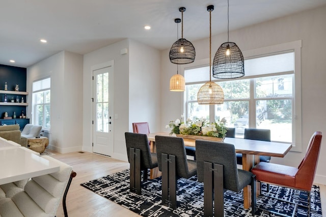 dining space with light hardwood / wood-style flooring