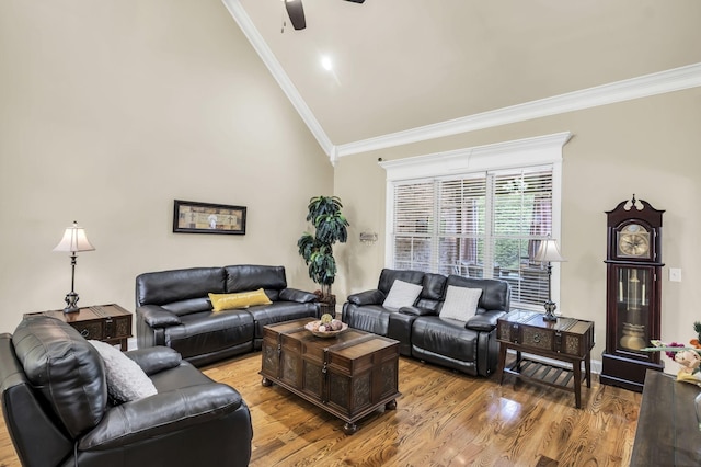 living room featuring lofted ceiling, crown molding, ceiling fan, and light wood-type flooring