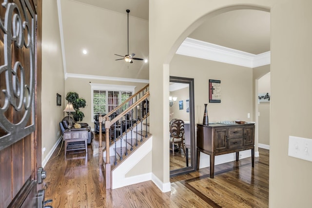 foyer with hardwood / wood-style floors, ornamental molding, and ceiling fan