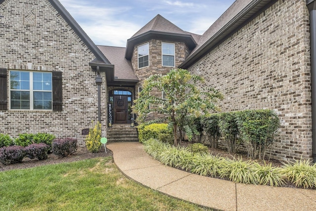 entrance to property with a lawn