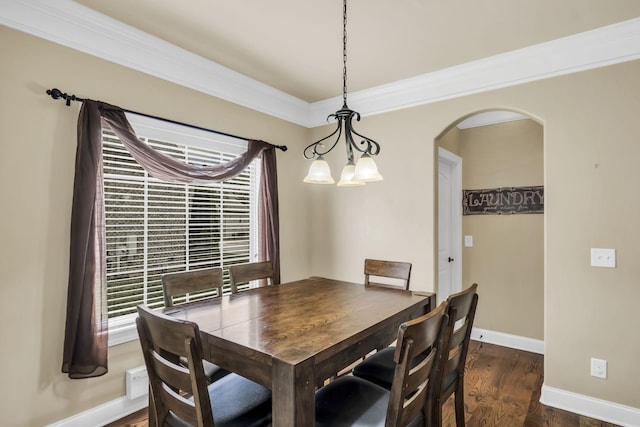 dining area featuring ornamental molding and dark wood-type flooring