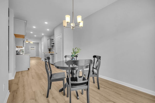 dining room featuring light hardwood / wood-style floors and a notable chandelier