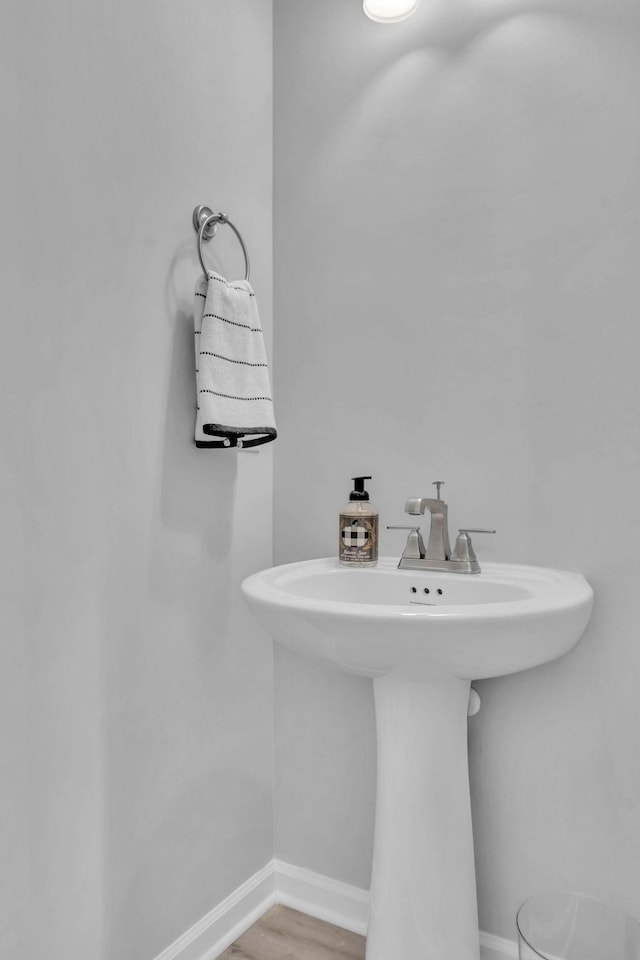 bathroom with wood-type flooring and sink