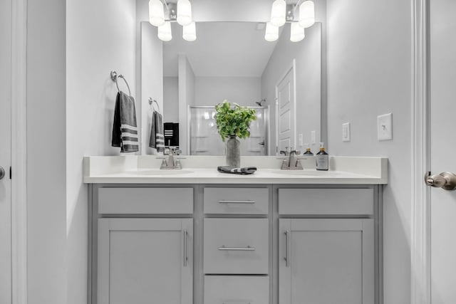 bathroom with vanity and a shower with door