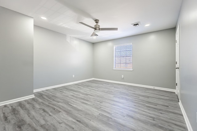 spare room with wood-type flooring and ceiling fan