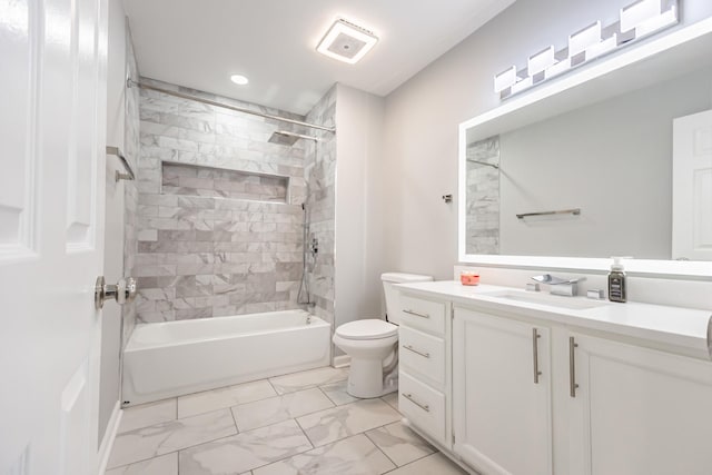 full bathroom featuring vanity, toilet, and tiled shower / bath