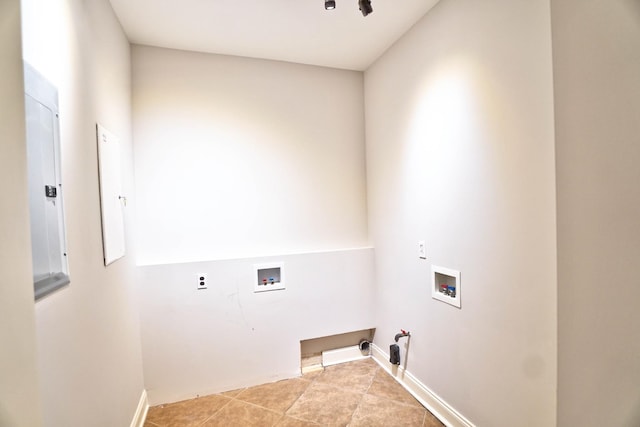 laundry area with hookup for a washing machine, gas dryer hookup, and light tile patterned floors