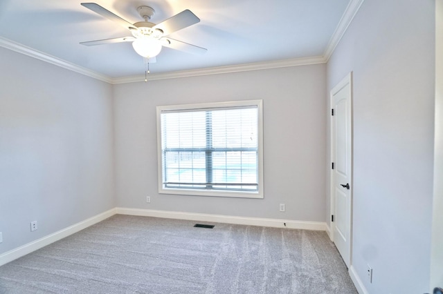 carpeted spare room with ornamental molding and ceiling fan