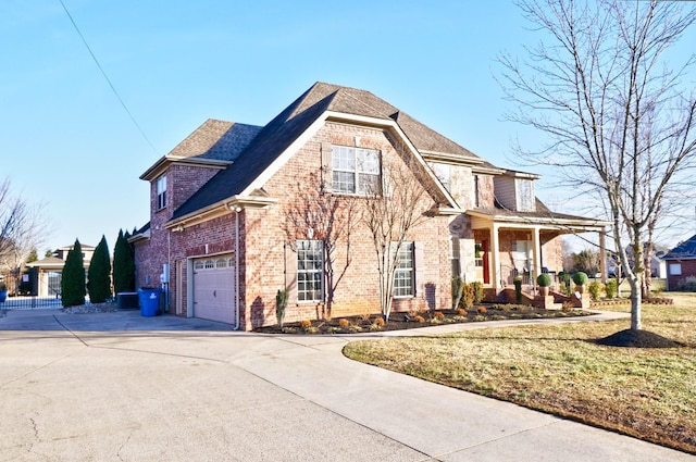 exterior space with a garage and a lawn