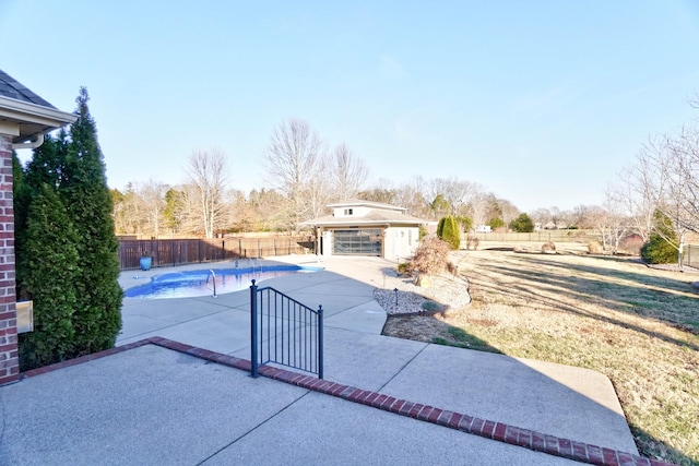 view of pool with a patio and an outbuilding