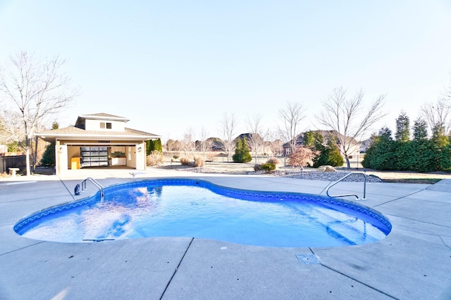 view of swimming pool featuring an outdoor structure and a patio area