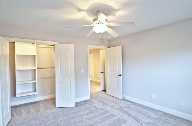 unfurnished bedroom with light carpet, a closet, and ceiling fan