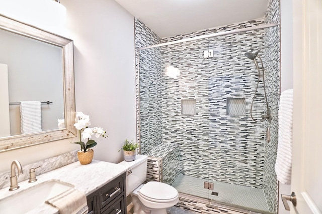 bathroom featuring vanity, toilet, and an enclosed shower