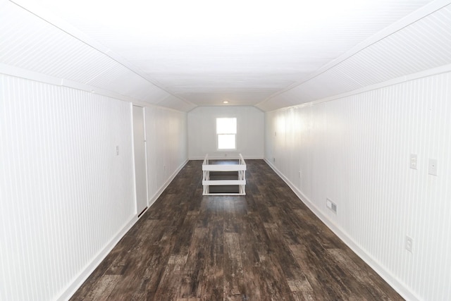 interior space featuring dark wood-type flooring and vaulted ceiling