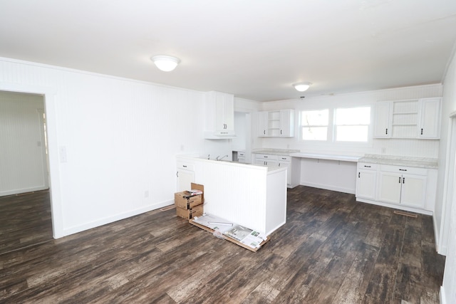 kitchen with dark wood-type flooring and white cabinets