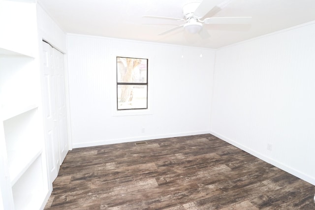 unfurnished room featuring dark hardwood / wood-style flooring, crown molding, and ceiling fan