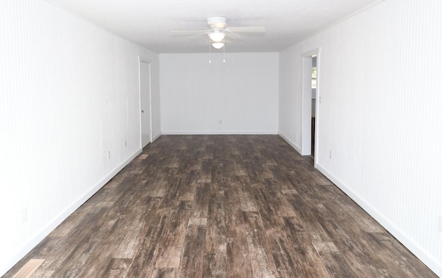 spare room with dark wood-type flooring and ceiling fan