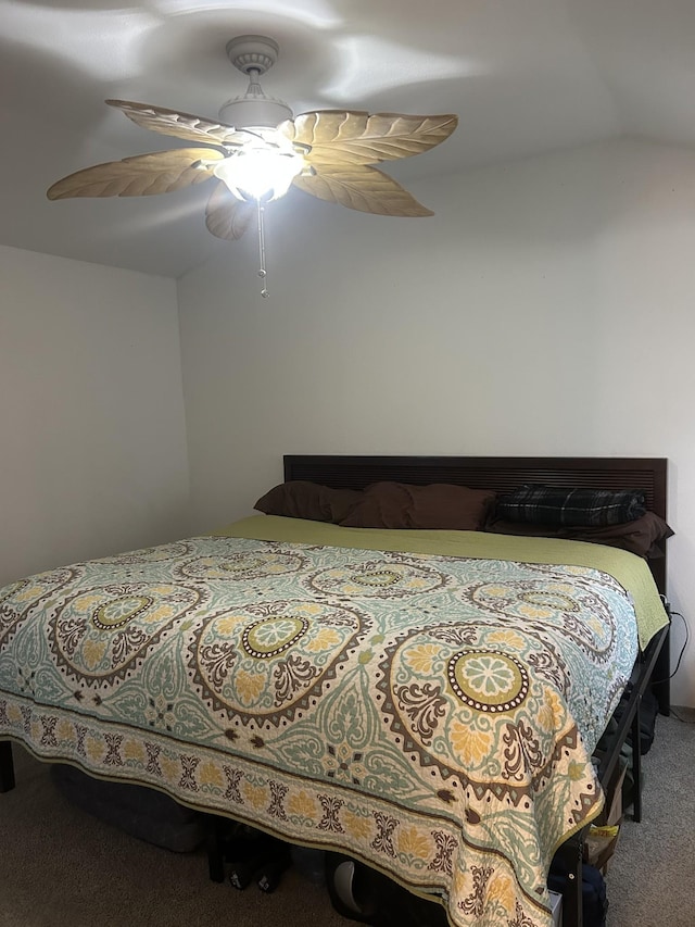 carpeted bedroom with vaulted ceiling and ceiling fan