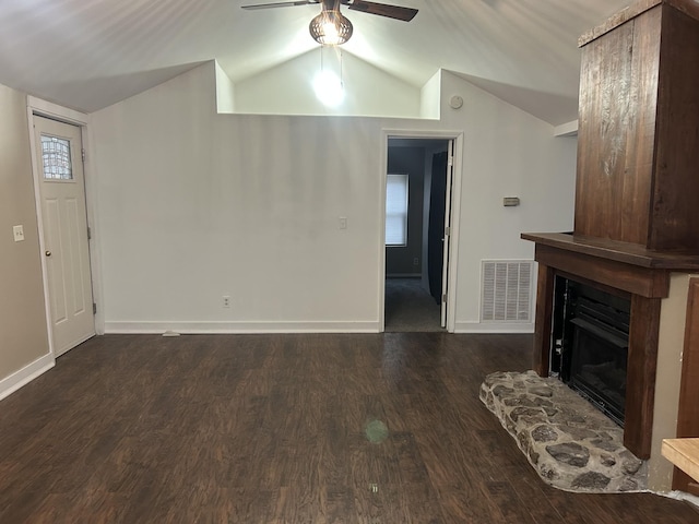 unfurnished living room with dark wood-type flooring, ceiling fan, lofted ceiling, and a fireplace