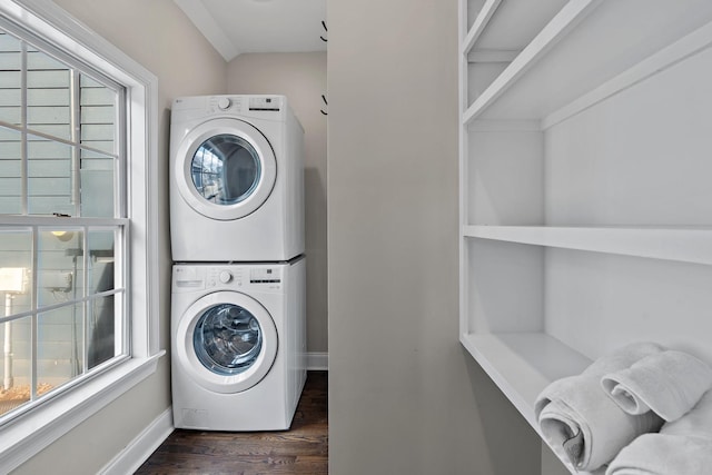 washroom featuring a healthy amount of sunlight, stacked washer / drying machine, and dark hardwood / wood-style floors