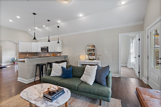 living room featuring lofted ceiling, crown molding, and dark hardwood / wood-style floors