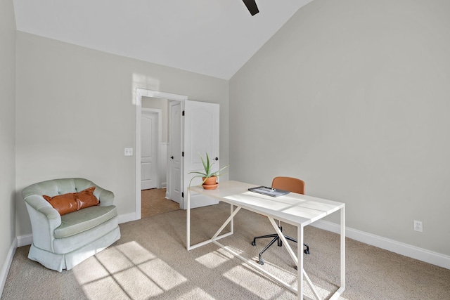 carpeted home office featuring lofted ceiling