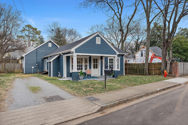 bungalow-style home with a porch and a front yard