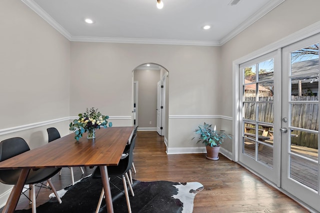 dining space featuring french doors, ornamental molding, and dark hardwood / wood-style floors