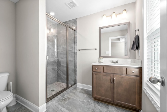 bathroom with walk in shower, vanity, and toilet