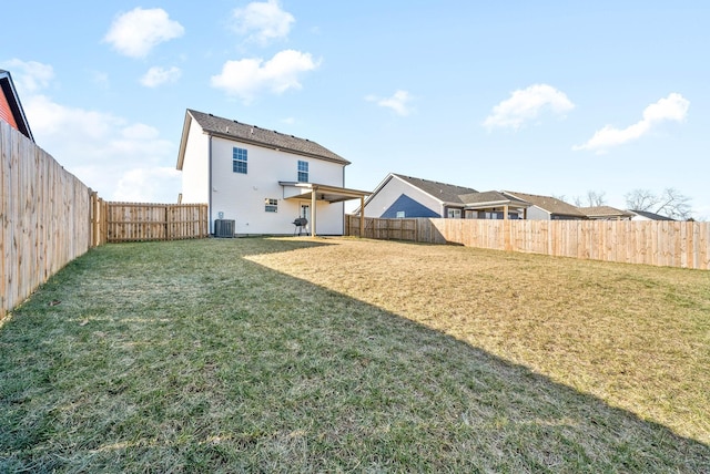 back of house with central AC and a lawn