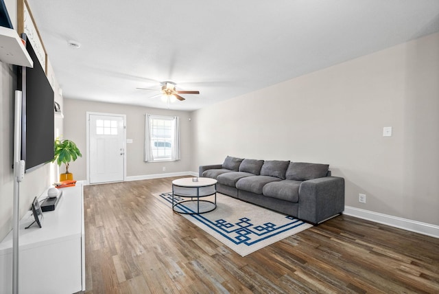 living room featuring wood-type flooring and ceiling fan