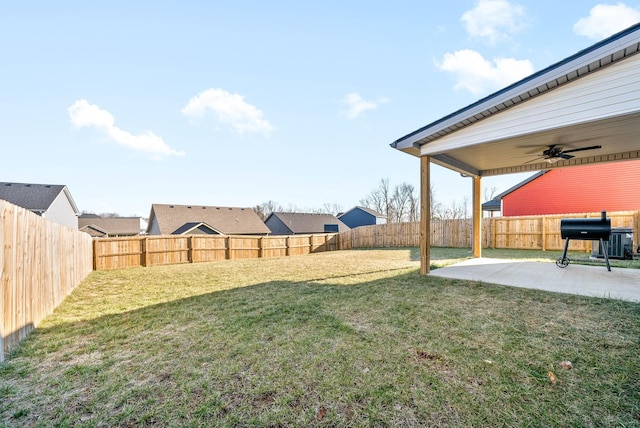 view of yard featuring ceiling fan and a patio