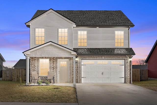 view of front facade with a garage and a lawn