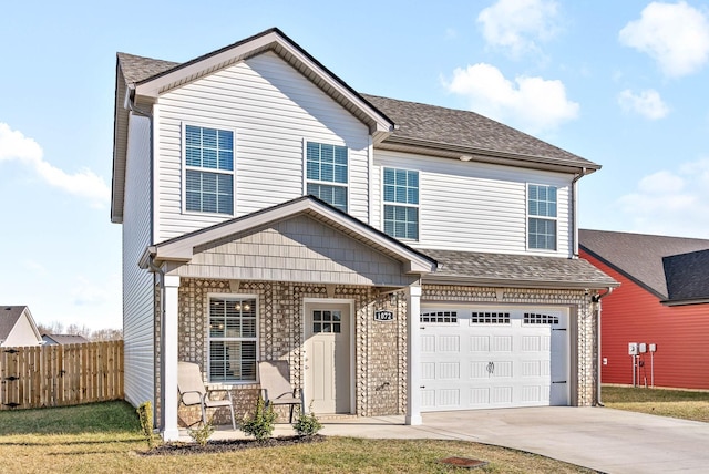 view of property featuring a garage and a front yard