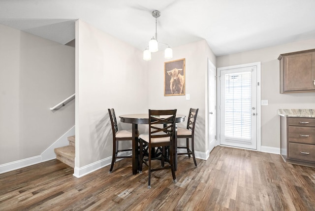 dining room featuring a notable chandelier and dark hardwood / wood-style floors