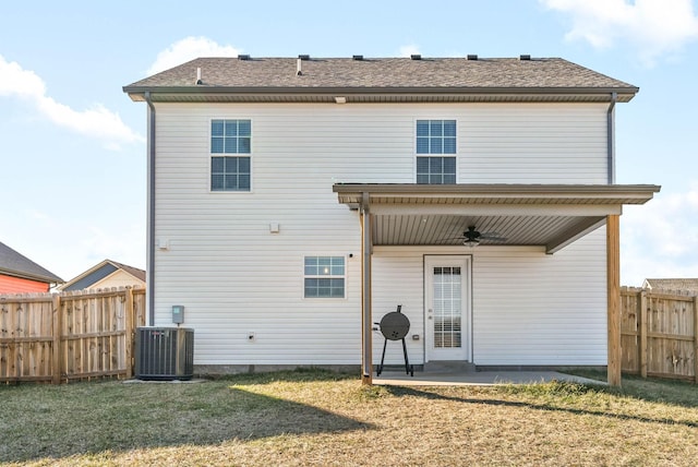 back of property featuring central AC unit, a patio area, ceiling fan, and a lawn